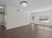 Thumbnail 2 of 26 - the living room and dining room of an empty house with wood floors and a window
