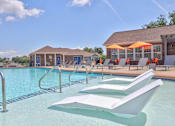Thumbnail 1 of 20 - A pool with a white sun lounger in the foreground.