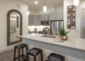 Thumbnail 1 of 34 - a kitchen with a granite counter top and stools