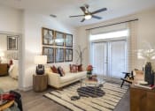 Thumbnail 4 of 34 - a living room with a couch and a ceiling fan