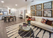 Thumbnail 5 of 34 - a living room with a couch and a table