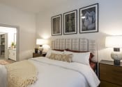 Thumbnail 20 of 34 - a bedroom with a bed and pictures on the wall