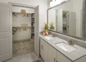 Thumbnail 7 of 34 - a bathroom with two sinks and a mirror and a closet