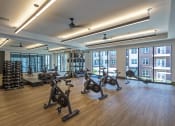 Thumbnail 27 of 34 - a gym with exercise bikes and windows in a building