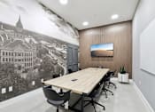 Thumbnail 7 of 31 - A conference room with a large printed image of a building on the wall.