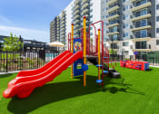 Thumbnail 33 of 37 - a playground at an apartment building with a red slide