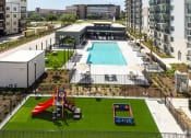 Thumbnail 32 of 37 - an aerial view of an apartment complex with a swimming pool and a playground