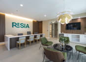 Thumbnail 19 of 37 - a lobby with a reception desk and a table with chairs