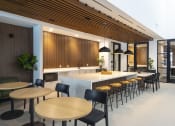 Thumbnail 24 of 37 - a kitchen and dining area with wooden tables and chairs