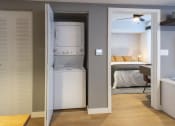 Thumbnail 3 of 37 - a room with a washer and dryer in a closet next to a bedroom