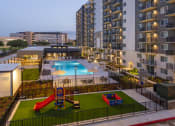 Thumbnail 37 of 37 - an aerial view of an apartment complex with a pool and playground