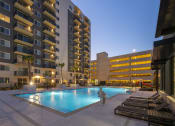 Thumbnail 35 of 37 - a swimming pool in front of an apartment building at night