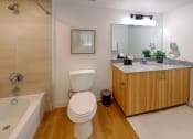 Thumbnail 11 of 37 - a bathroom with a toilet and a sink and a bath tub