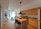 Thumbnail 6 of 37 - a kitchen with wooden cabinets and a island with three stools
