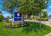 Thumbnail 1 of 35 - A sign for The Residences at the entrance to a gated community.