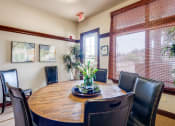 Thumbnail 16 of 30 - a dining room with a wooden table and leather chairs