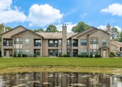 Thumbnail 29 of 30 - a large building with a pond in front of it