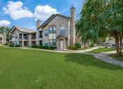 Thumbnail 30 of 30 - a large house with a green lawn and trees in front of it