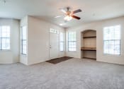 Thumbnail 5 of 30 - an empty living room with a ceiling fan