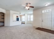 Thumbnail 4 of 30 - an empty living room with a ceiling fan