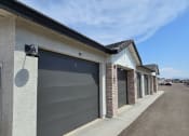 Thumbnail 30 of 30 - the front of a building with a gray garage door