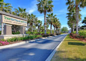 Thumbnail 15 of 26 - A street view of The Retreat at Pinecrest Luxury Apartments.