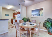 Thumbnail 8 of 26 - A dining room with a table set for four.