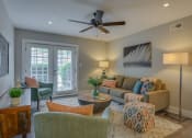 Thumbnail 1 of 36 - a living room with a couch and chairs and a ceiling fan
