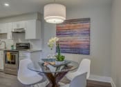 Thumbnail 8 of 36 - a kitchen and dining room with a glass table and chairs