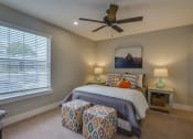 Thumbnail 9 of 36 - a bedroom with a bed and a ceiling fan
