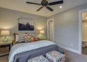 Thumbnail 11 of 36 - a bedroom with a bed and a ceiling fan