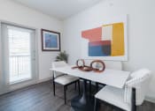 Thumbnail 5 of 36 - a dining room with a white table and chairs and a window
