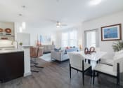 Thumbnail 4 of 36 - a living room with a dining room table and a kitchen