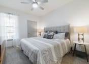 Thumbnail 10 of 36 - a bedroom with a bed and a ceiling fan