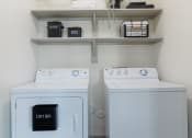 Thumbnail 9 of 36 - a washer and dryer in a laundry room with shelves