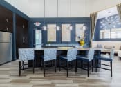 Thumbnail 18 of 36 - a dining room with a table and chairs and a kitchen