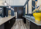 Thumbnail 17 of 36 - a large kitchen with black cabinets and a yellow vase
