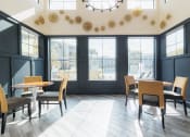 Thumbnail 16 of 36 - a dining room with tables and chairs and a large window