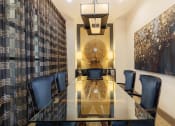 Thumbnail 21 of 36 - a dining room with a long glass table and blue chairs