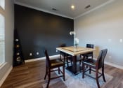 Thumbnail 15 of 26 - a dining room with a table and chairs and a large window