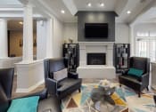 Thumbnail 13 of 26 - a living room with black leather chairs and a fireplace