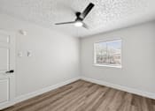 Thumbnail 27 of 38 - A room with a ceiling fan and a window with blinds.