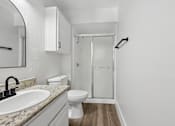 Thumbnail 17 of 38 - A bathroom with a sink, toilet, and shower.