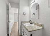 Thumbnail 18 of 38 - A bathroom with a sink and mirror.