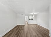 Thumbnail 14 of 38 - A room with wooden flooring and white walls.
