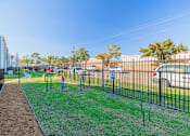 Thumbnail 28 of 40 - A playground with a swing set and a blue slide.