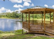Thumbnail 17 of 19 - a gazebo by a pond with a fountain