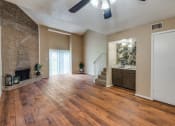 Thumbnail 10 of 16 - an empty living room with a fireplace and wooden floors
