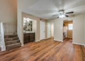 Thumbnail 9 of 16 - an empty living room and kitchen with a ceiling fan