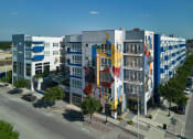 Thumbnail 1 of 24 - a large building with a colorful mural on the side of it